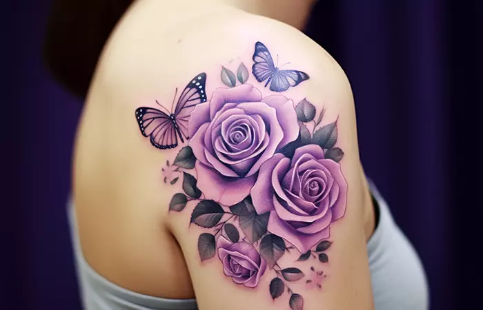A hyper-realistic butterfly and purple rose tattoo on the shoulder