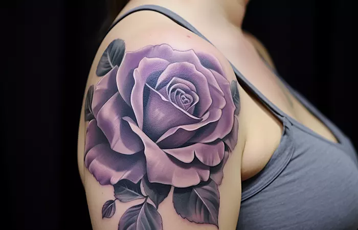 A large purple rose tattoo on the shoulder