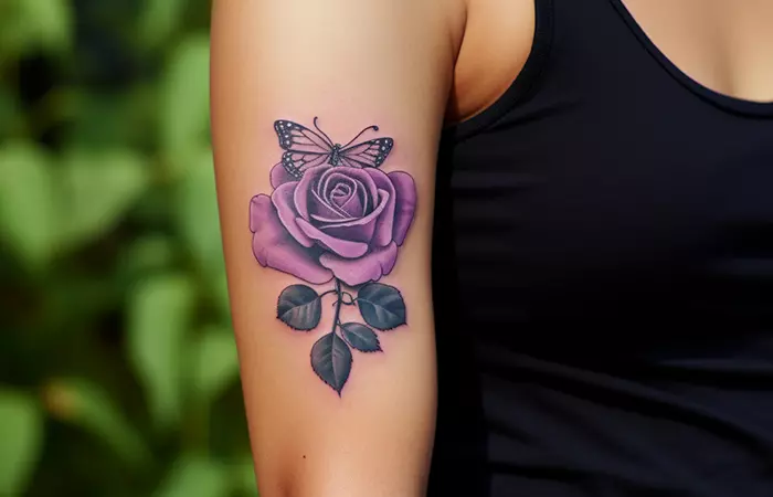 A minimal butterfly and purple rose tattoo