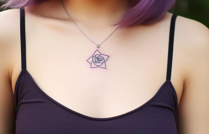 A minimal pendant style small purple rose tattoo