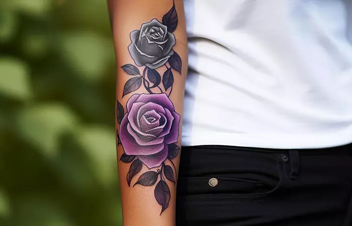 A pair of purple and black rose flowers for a forearm tattoo