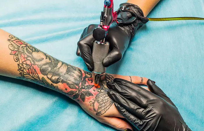 A person getting a tattoo may experience pain