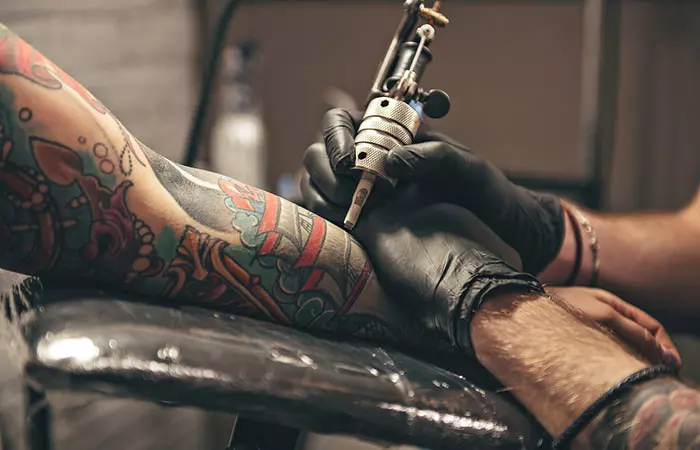 A person getting tattooed at a clean tattoo studio