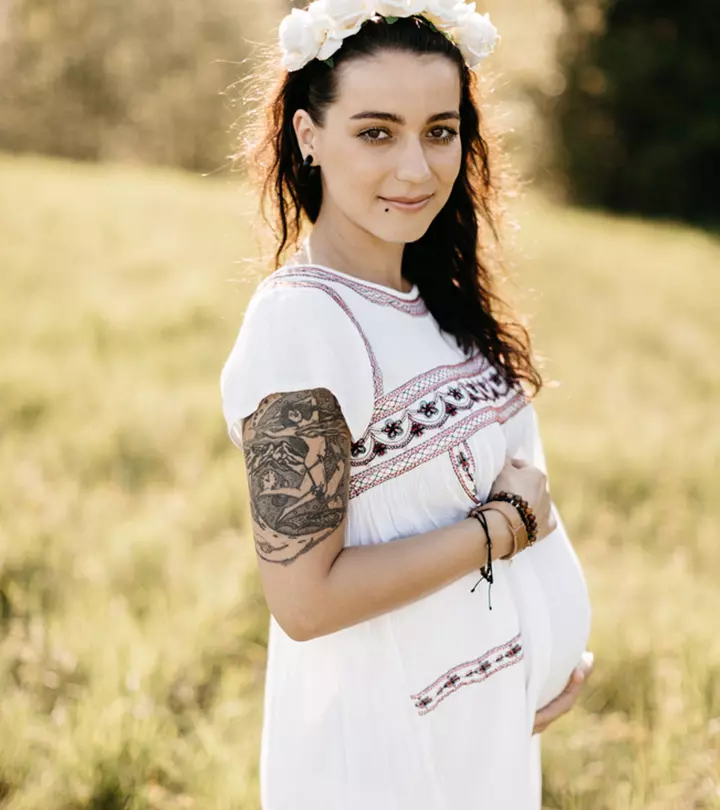 A pregnant woman with an arm tattoo