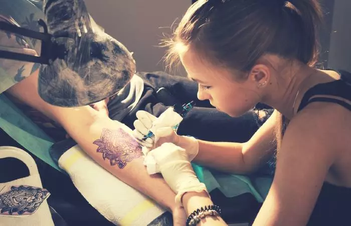 A professional tattoo artist doing a tattoo