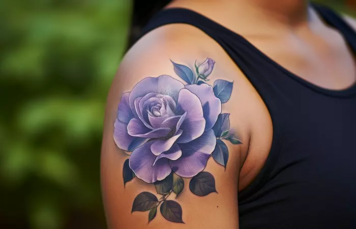 A single pastel purple rose tattoo on the shoulder