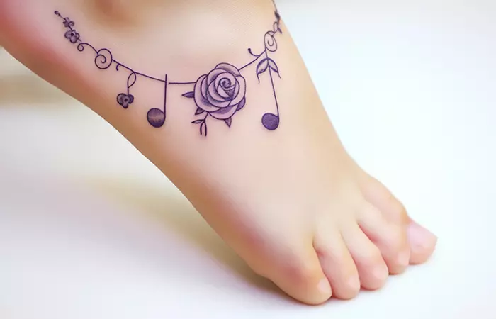A small rose anklet tattoo