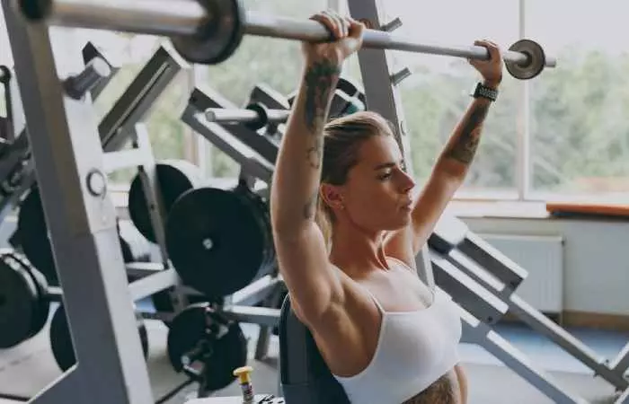 A tattooed woman working out
