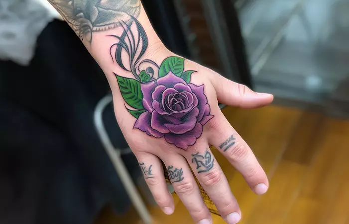 A traditional tribal rose tattoo on the back of the hand