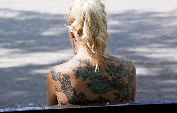 A woman with tattoos on the back
