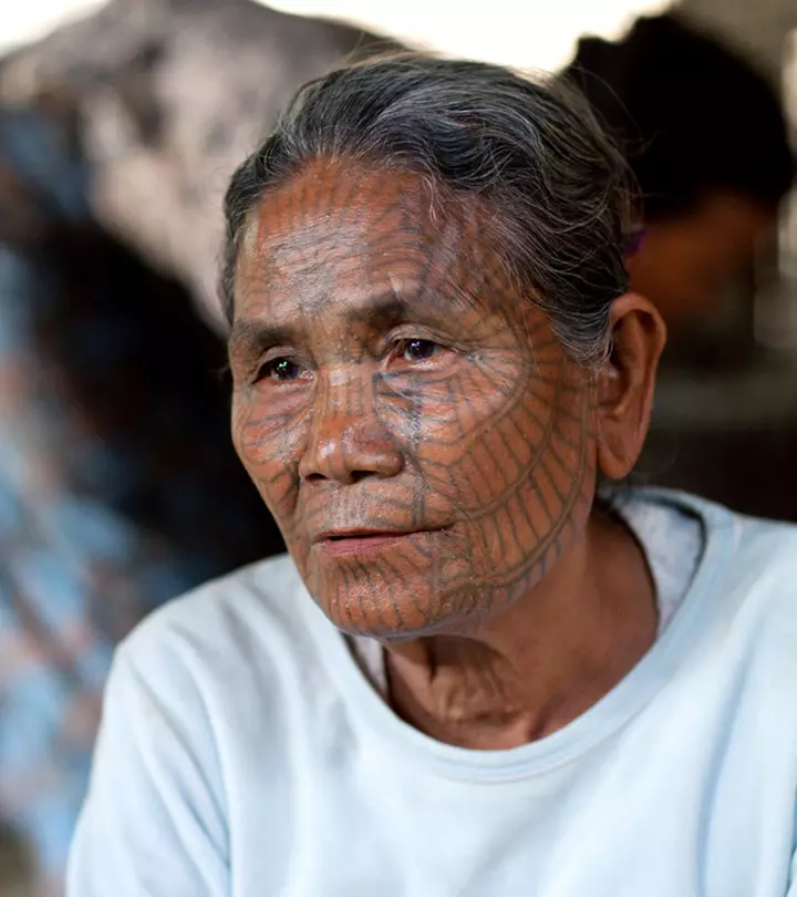 An elderly native woman with ethnic face tattoos