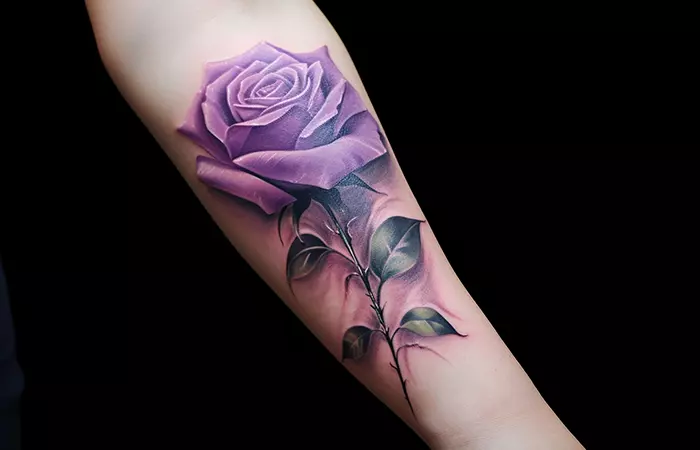 An ultra-realistic purple rose tattoo on the forearm