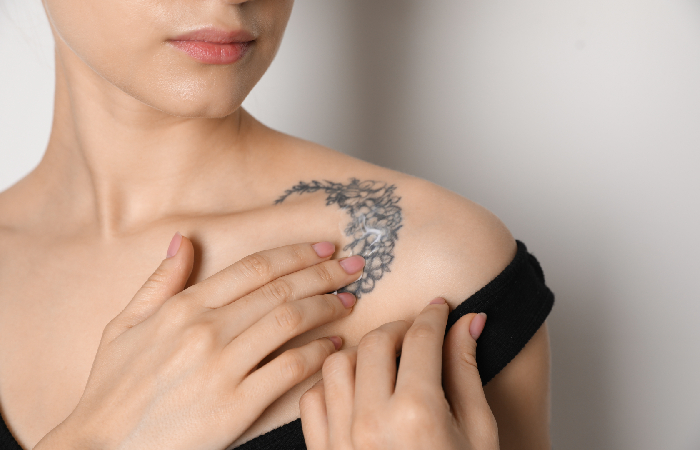 Applying moisturizer on tattoo