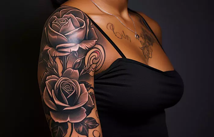 Two black roses tattooed across the shoulder area
