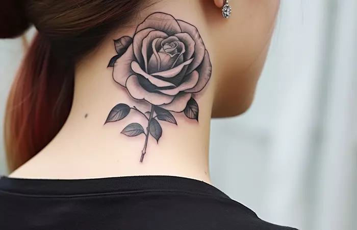 A large traditional black and gray rose neck tattoo