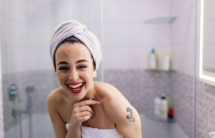 A woman with a tattoo in the shower