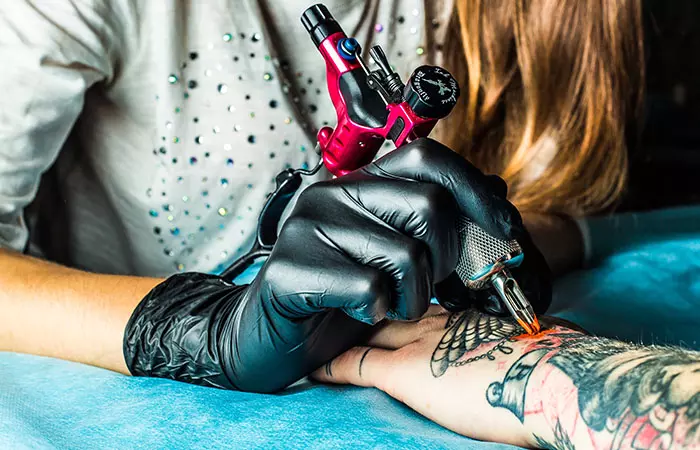 A tattoo artist making a tattoo