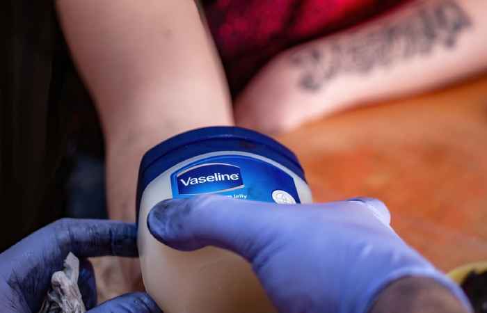 Tattoo artist using Vaseline for lubrication