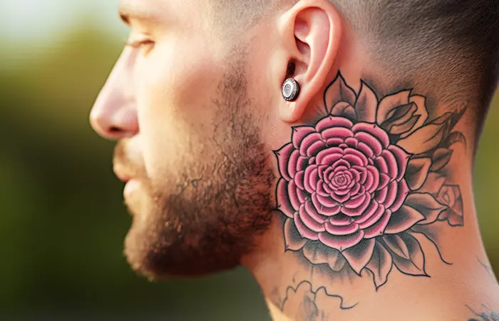A maximal mandala rose neck tattoo behind the ear