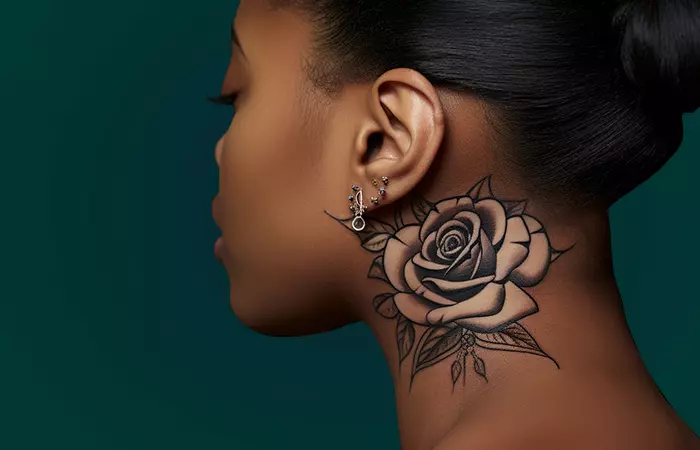 A black woman with a realistic nude rose neck tattoo