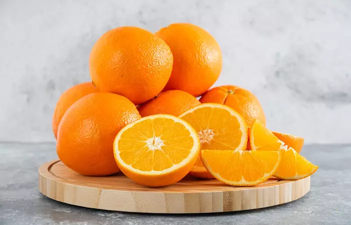 Fresh oranges on a wooden board