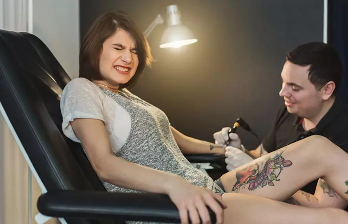 Woman experiences pain while tattoo removal