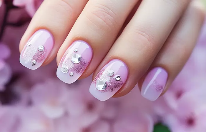 A soft pink ombré effect with glitter and rhinestones