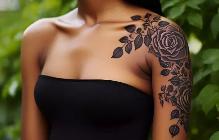 A traditional dark art rose tattoo on the shoulder