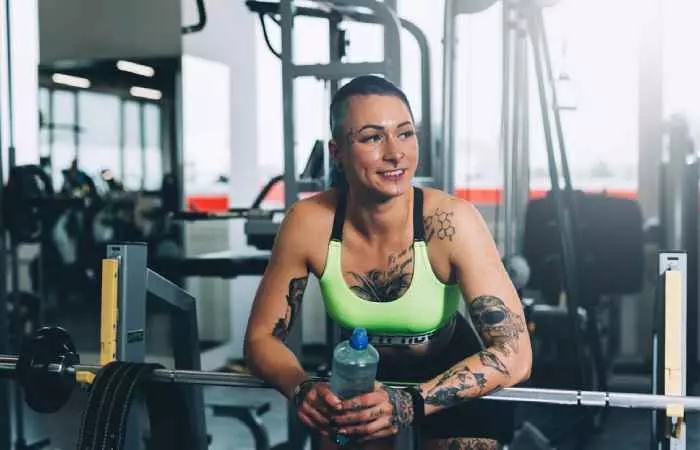 Tattooed woman working out in the gym