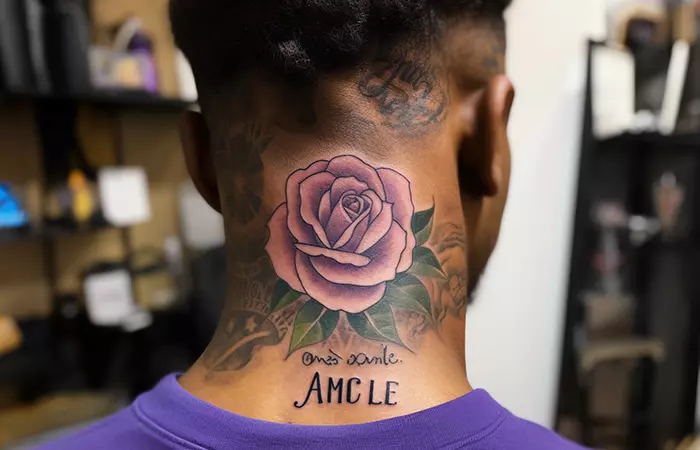 The name Amcle tattooed below the rose tattoo on the nape