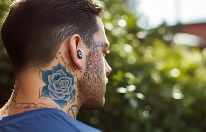 A muted blue rose neck tattoo