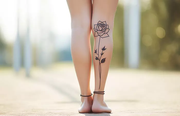 A basic rose tattoo on a woman’s calf
