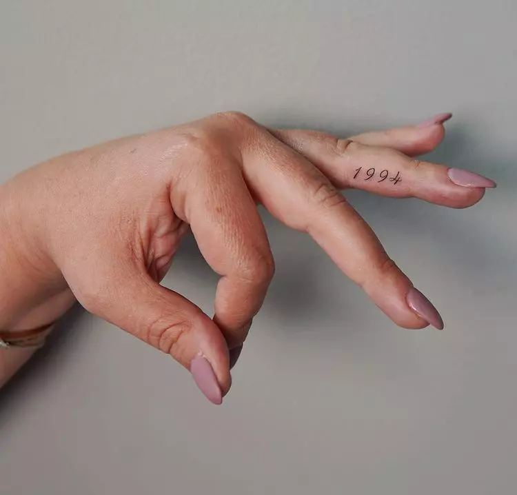 Birth year finger tattoo