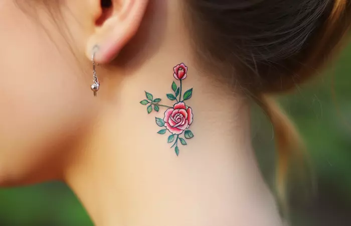 A colorful miniature rose neck tattoo behind the ear