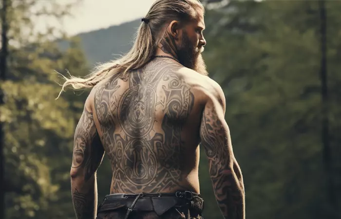 A man with Viking symbols and motifs tattooed on his back