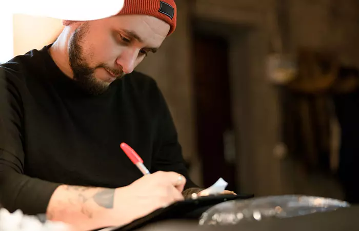 A tattoo artist sketching