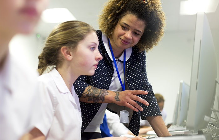 A teacher with a tattoo on her forearm