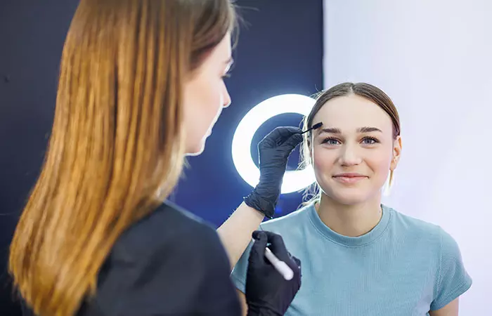A woman consulting a qualified professional for her eyebrow tattoo
