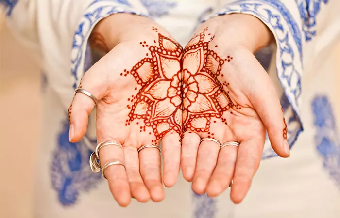 A woman with a henna tattoo on both palms