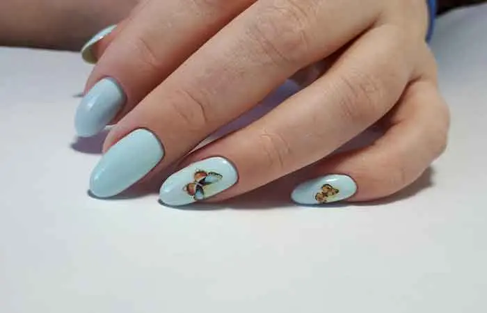 A woman with blue butterfly designed nails