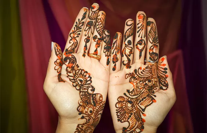 A woman with dried henna on her palms