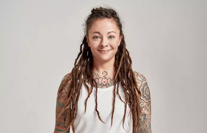 A woman with tattoos on her chest and arms
