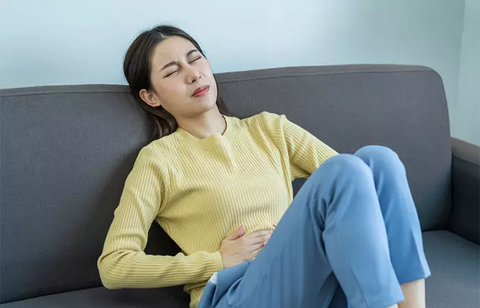 A young woman experiencing stomach pain