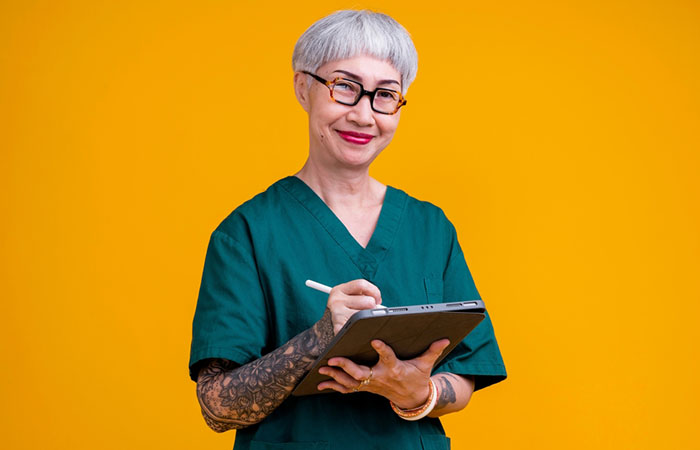 An elderly nurse with tattoos