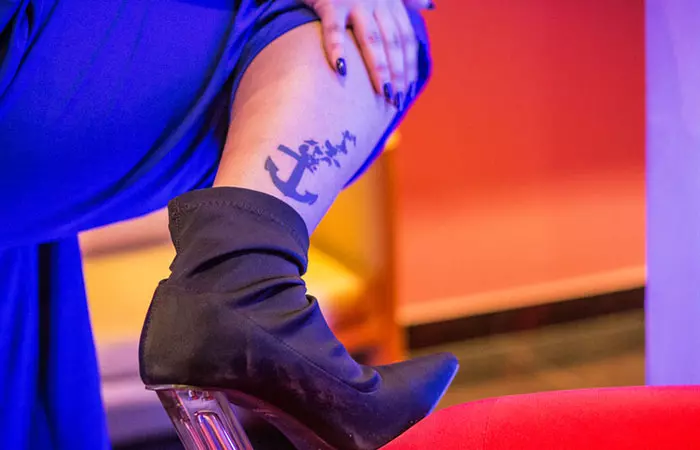 A woman with an anchor tattoo on her right leg