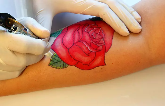 Close up of a traditional rose tattoo on the arm