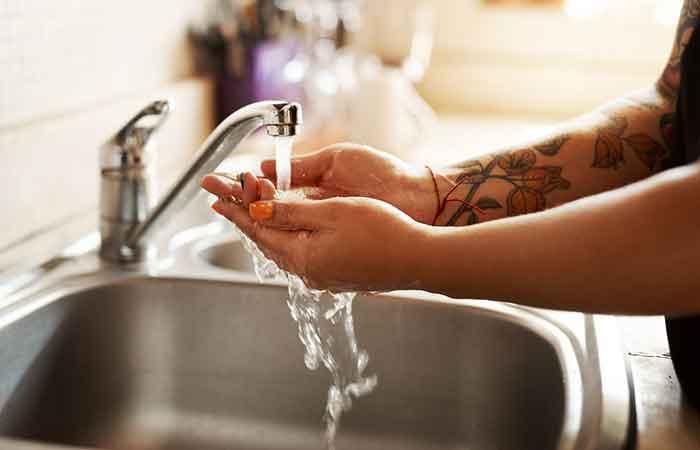 Woman washing her tattoo after using a sauna