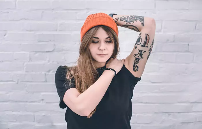 A woman with multiple tattoos on her arms
