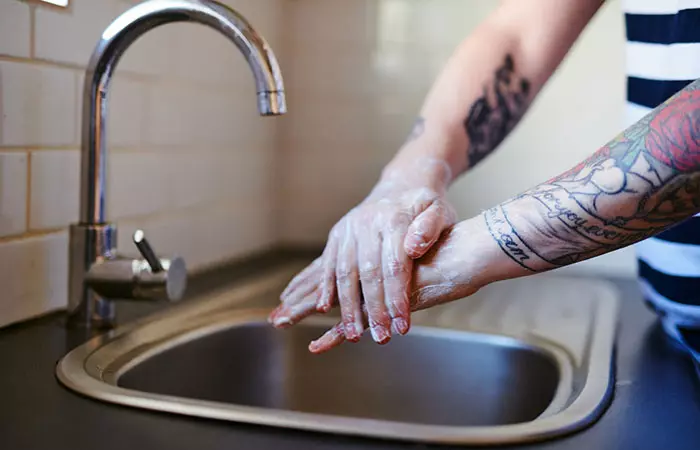 Person cleaning the tattoo with mild soap
