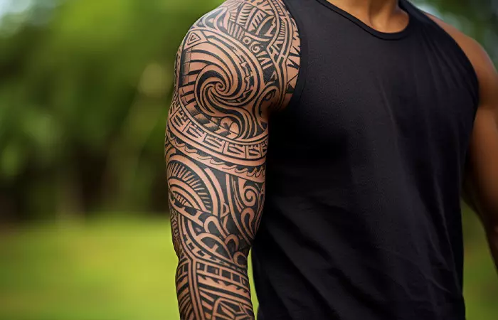 A man with maori tribal tattoo on his arm